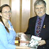 Click for larger view. Melynda Jarratt gives Senator Romeo Dallaire English and Dutch language copies of Voices of the Left Behind. May 7, 2005, Ottawa, Ontario. 