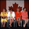 Click for larger picture. Official party on stage at the Dedication Ceremony of the Memorial Plaque, August 26, 2000. Marguerite Turner of the NS War Brides is at left. Photo: Parks Canada.