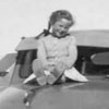 Jackie Scott perched on top of her father's car which clearly shows Ontario license plates, 1950. Click for larger image.